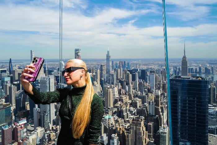 Женщина делает селфи на смотровой площадке Edge at Hudson Yards в Нью-Йорке перед полным солнечным затмением в Северной Америке.